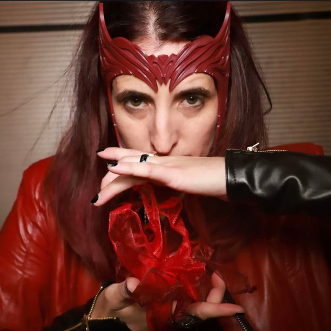 Person wearing a red mask and red outfit with a blurred background